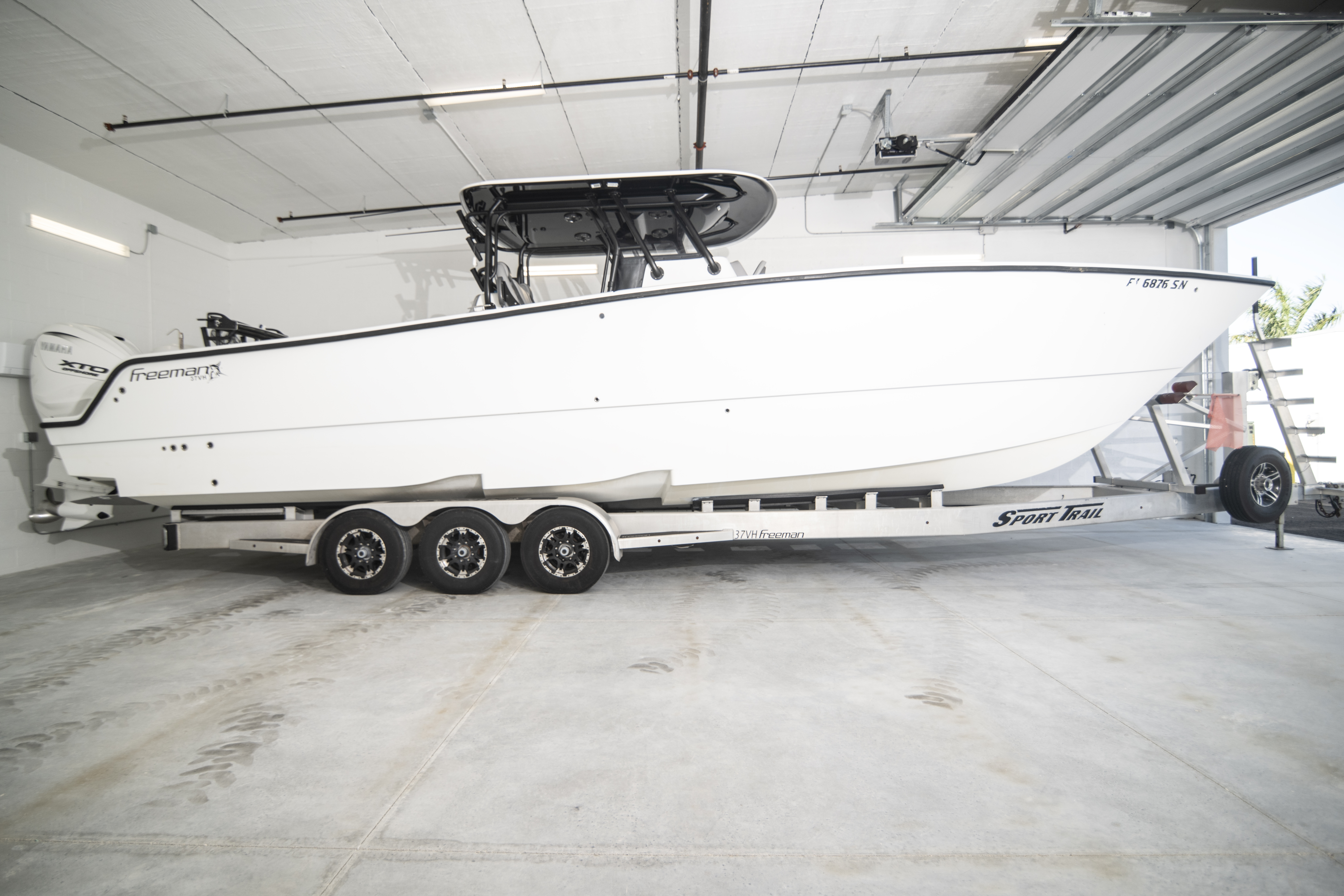 Boat Storage in Private Climate-Controlled Unit – MetroMaxx Fort Myers Large center-console boat stored on a trailer inside a private climate-controlled storage unit at MetroMaxx RV & Boat Storage in Fort Myers, Florida